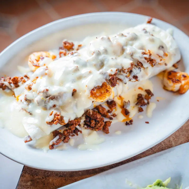 Smothered burrito with cheese sauce, chorizo and shrimp