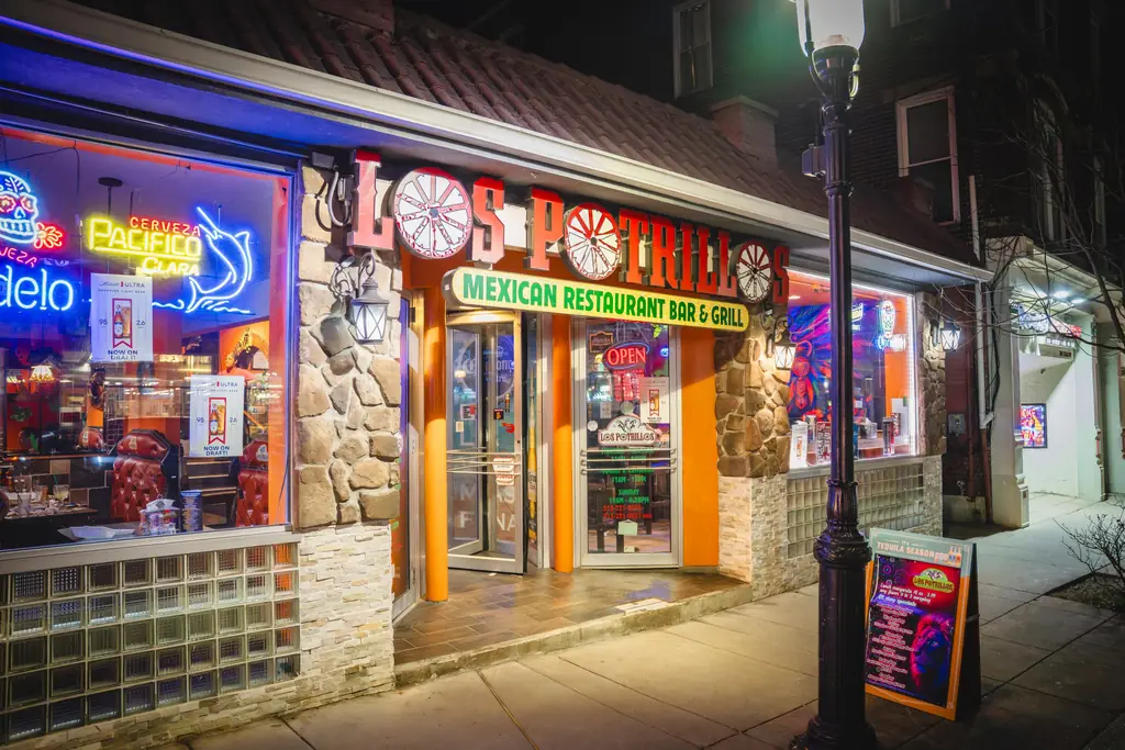 The Los Potrillos storefront on Ludlow Avenue at night