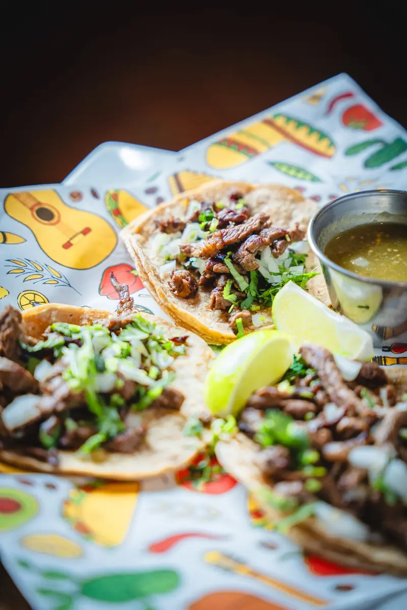 Street tacos with onion, cilantro, lime and salsa verde